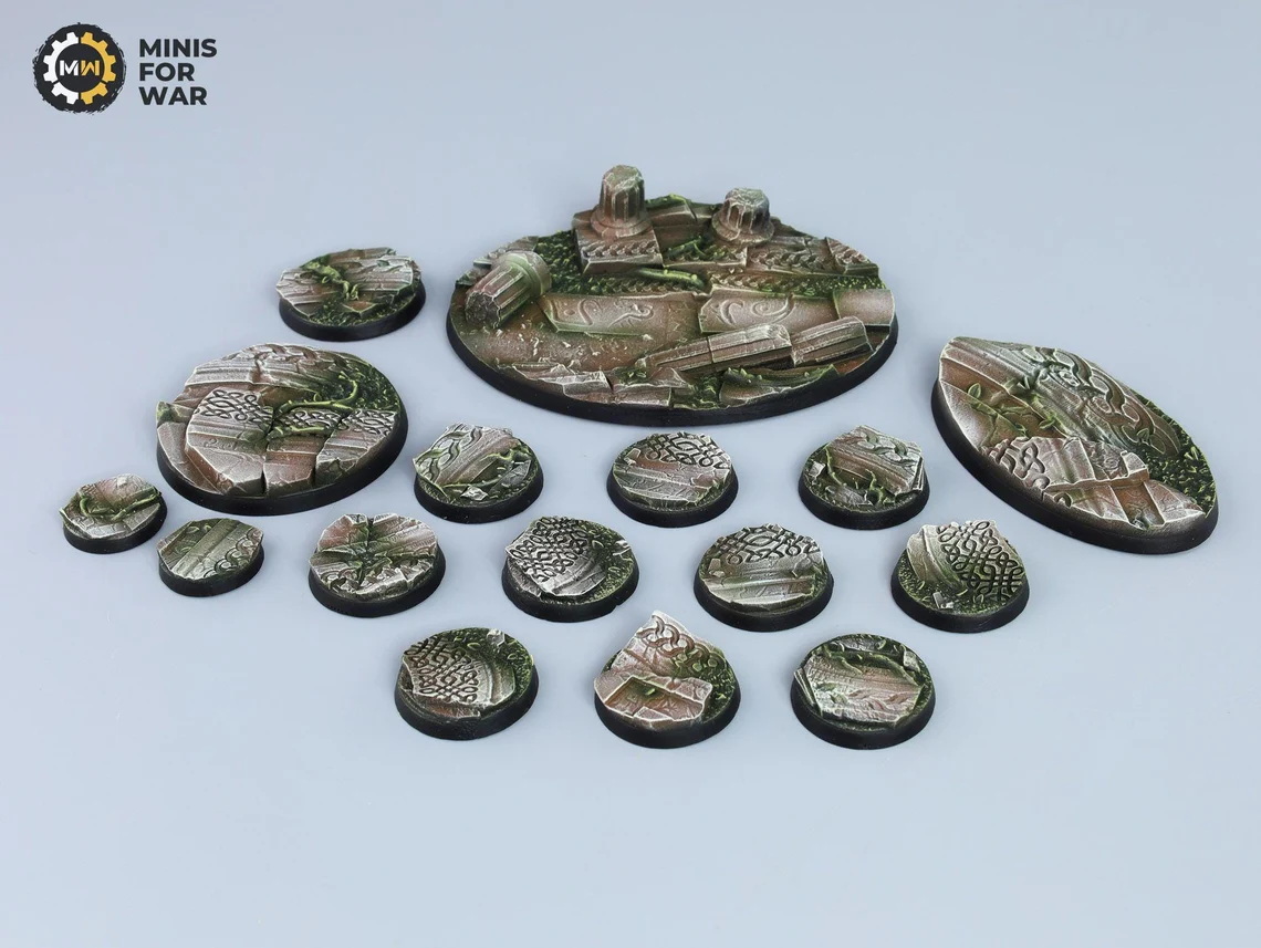 Miniature bases with engraved ruins, vine-covered patterns, and weathered stone
