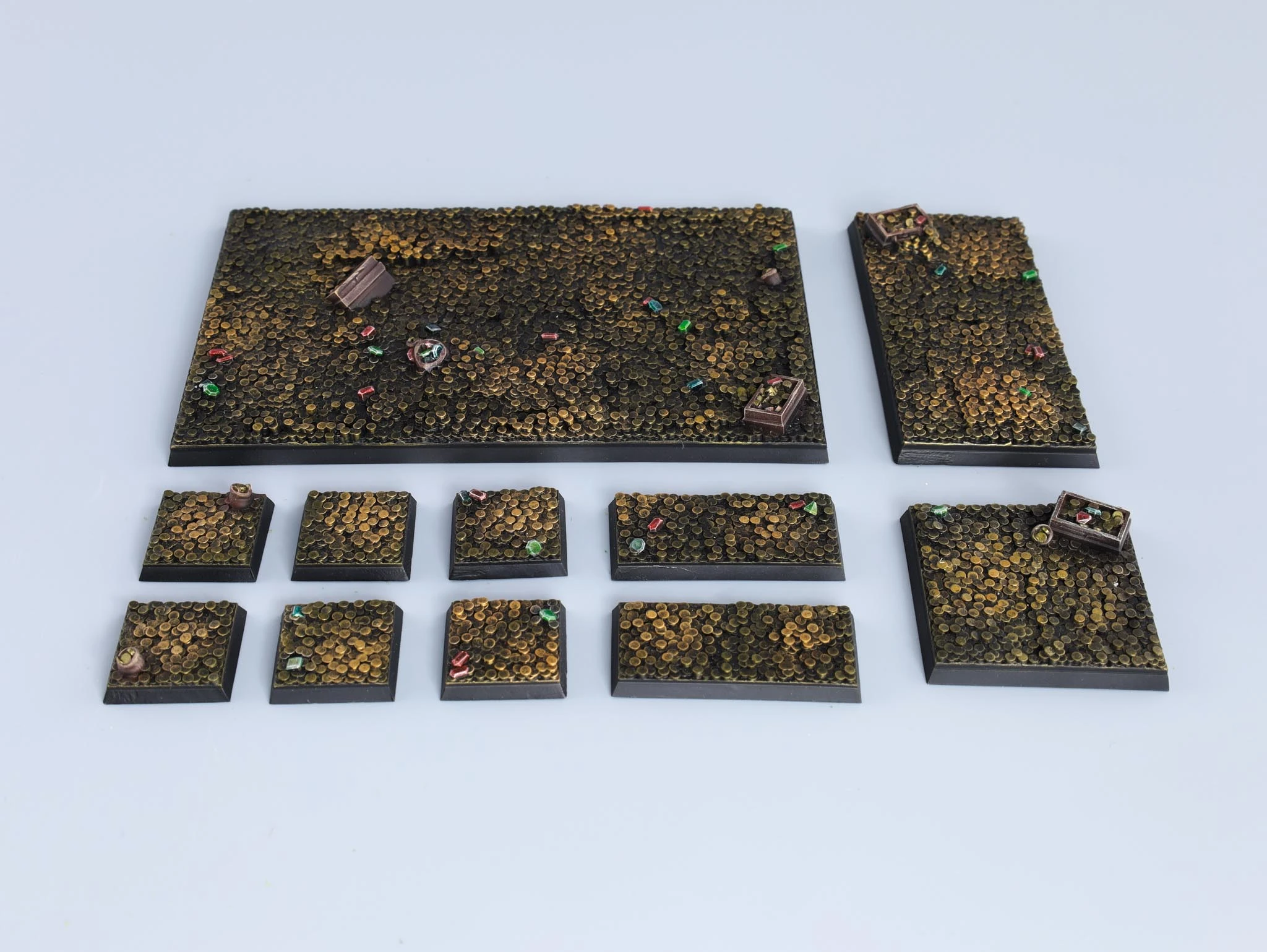 Red cracked-earth miniature bases with skeleton fragments and dry vegetation