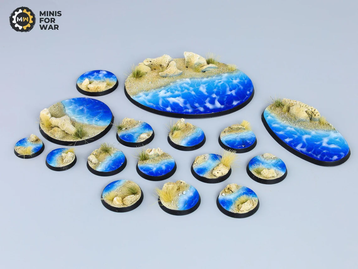 Blue and sand-colored miniature bases with water effects and sea-themed details