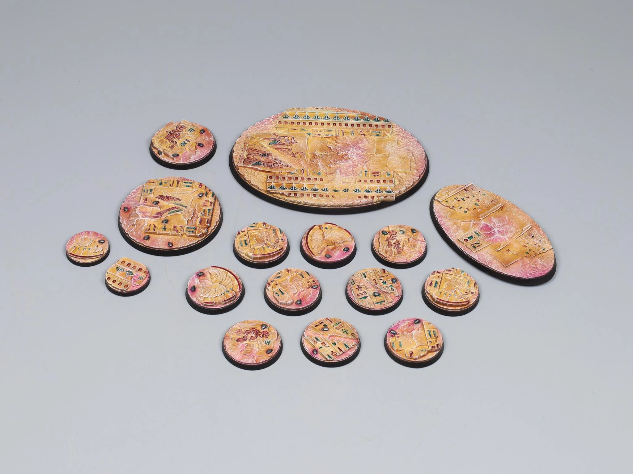 Red cracked-earth miniature bases with skeleton fragments and dry vegetation