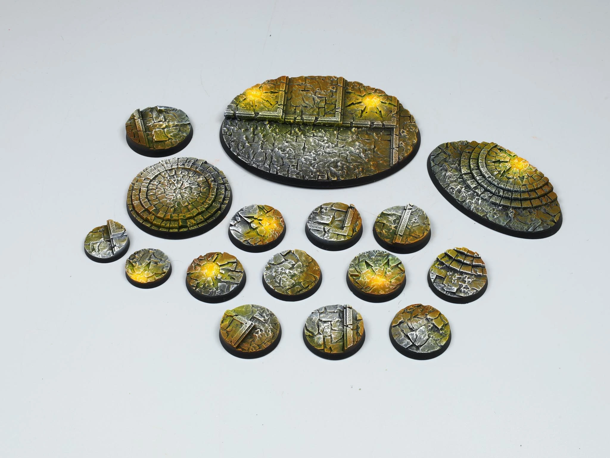 Red cracked-earth miniature bases with skeleton fragments and dry vegetation