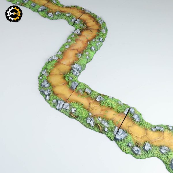Painted wargaming terrain showing a modular forest path with dirt textures.
